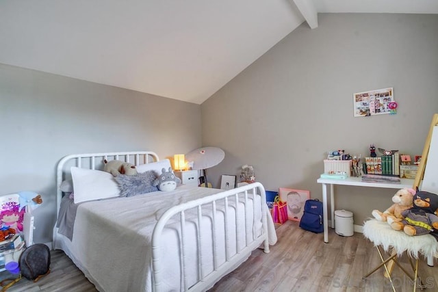 bedroom with hardwood / wood-style floors and vaulted ceiling with beams