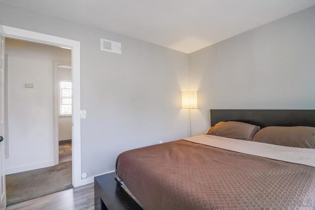 bedroom with hardwood / wood-style floors