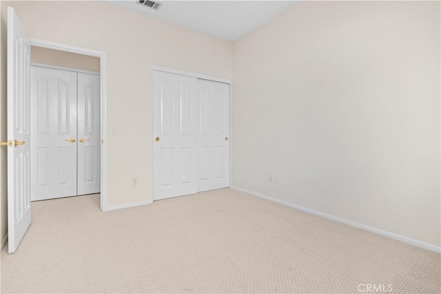 unfurnished bedroom featuring light colored carpet