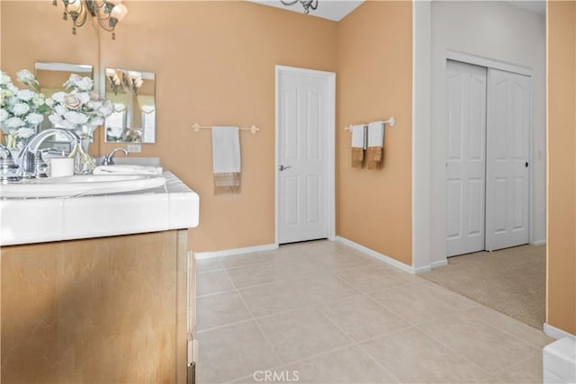 bathroom with vanity, tile patterned floors, and an inviting chandelier