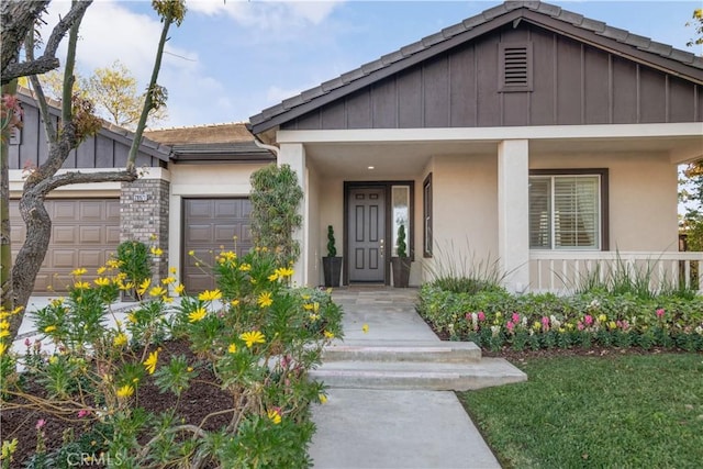 view of front of property with a porch and a garage