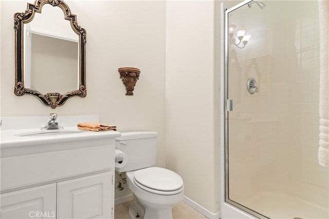 bathroom with vanity, tile patterned flooring, toilet, and walk in shower