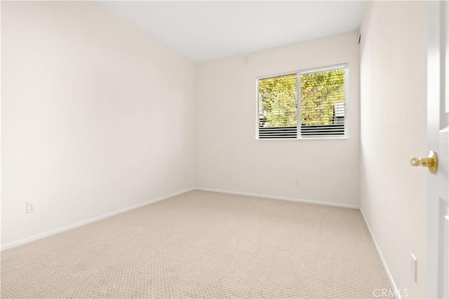 spare room with light carpet