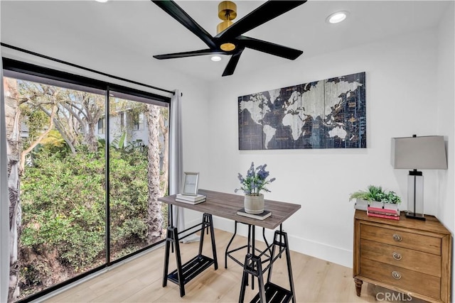 office space with ceiling fan and light hardwood / wood-style floors