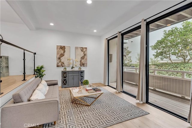 living room with beam ceiling and light hardwood / wood-style flooring