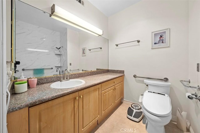 bathroom featuring toilet, vanity, tile patterned flooring, and a shower