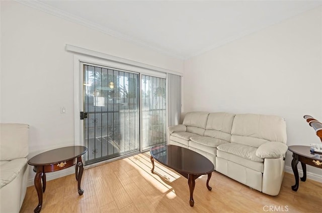 living room featuring light wood-type flooring and ornamental molding