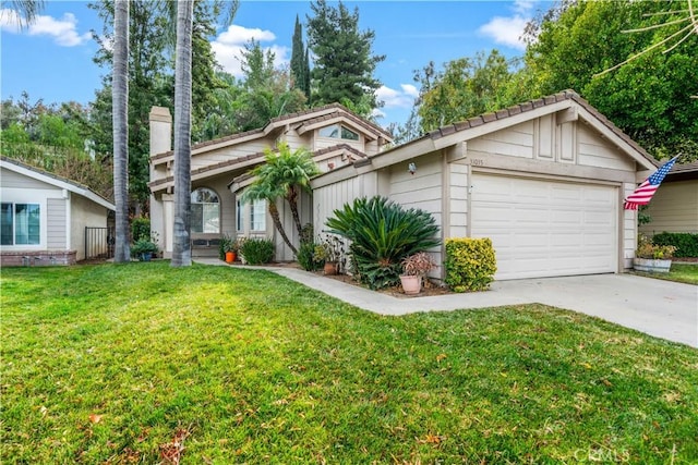 view of front of property with a front lawn and a garage