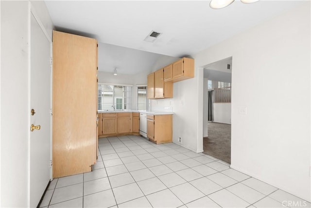 kitchen with light colored carpet, light brown cabinets, dishwasher, and sink