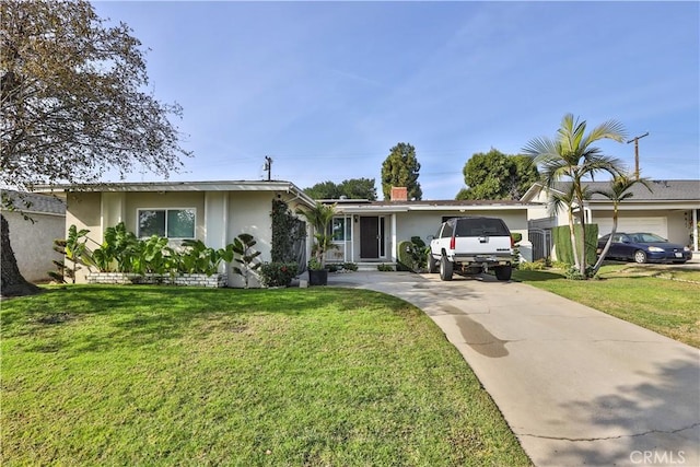 view of front of house featuring a garage and a front lawn