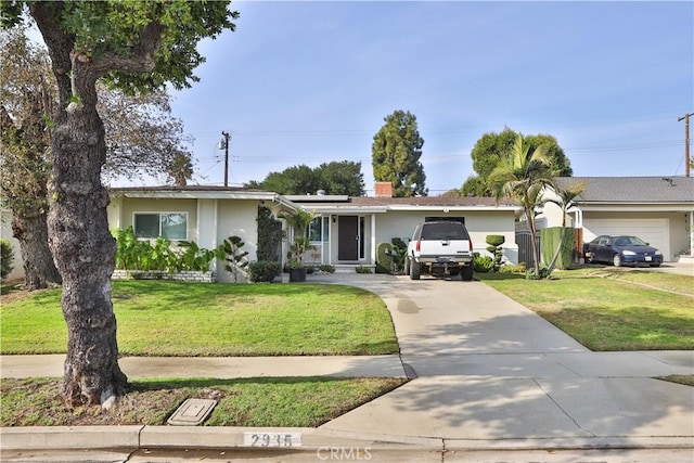 ranch-style house featuring a garage and a front lawn