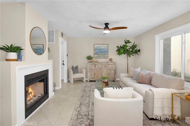 tiled living room with ceiling fan