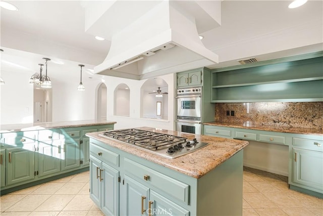 kitchen featuring pendant lighting, appliances with stainless steel finishes, a center island, green cabinetry, and custom exhaust hood