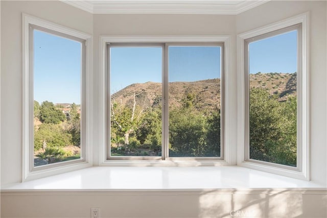 unfurnished sunroom with a mountain view and a healthy amount of sunlight