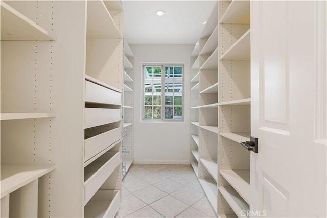 spacious closet featuring light tile patterned floors