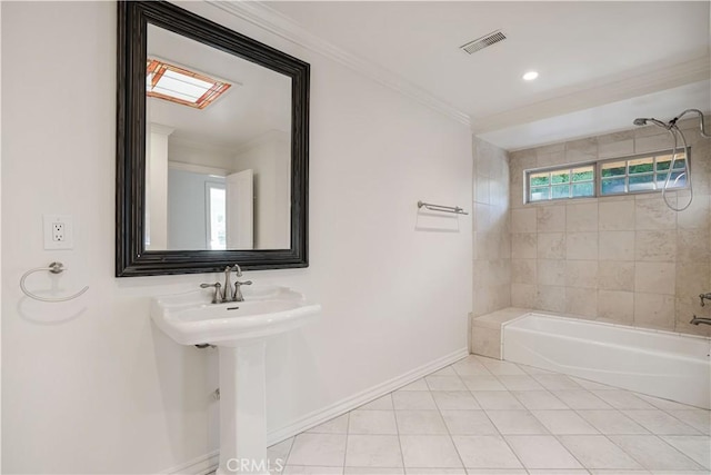 bathroom featuring tile patterned flooring, ornamental molding, tiled shower / bath combo, and sink