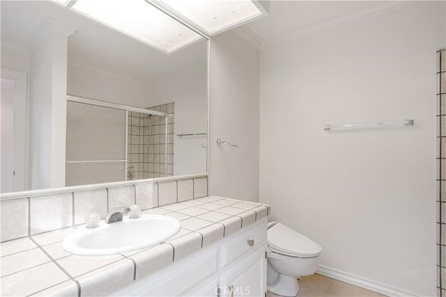 bathroom featuring ornamental molding, vanity, an enclosed shower, toilet, and tile patterned floors