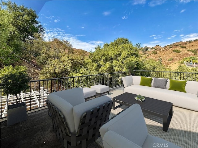 view of patio / terrace with a balcony and an outdoor hangout area