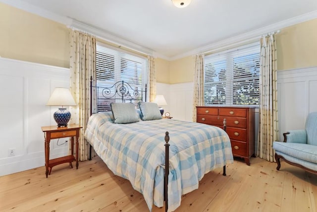 bedroom with ornamental molding and light wood-type flooring