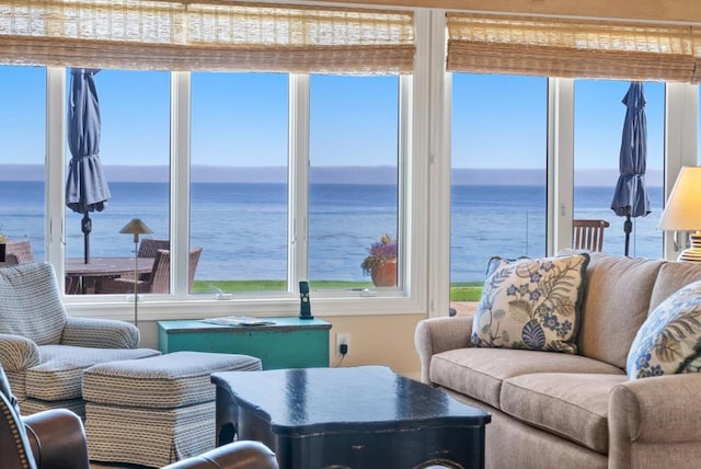 sunroom / solarium with a water view