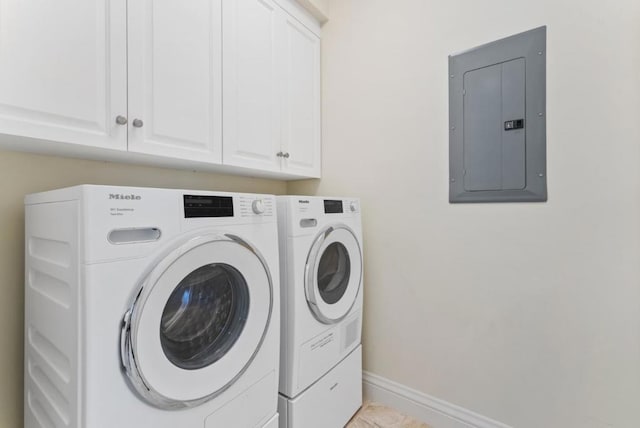 laundry area with cabinets, electric panel, and washing machine and dryer