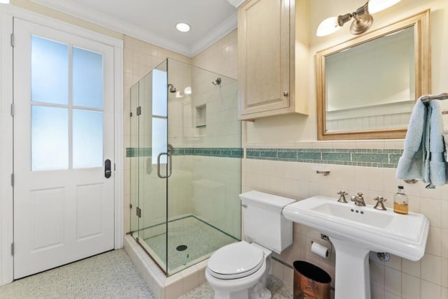 bathroom featuring sink, tile walls, ornamental molding, walk in shower, and toilet