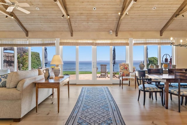 sunroom / solarium with a water view, wooden ceiling, a wealth of natural light, and vaulted ceiling with beams