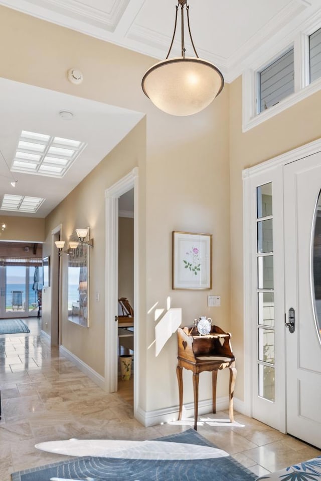 foyer entrance with french doors, ornamental molding, and light tile patterned floors