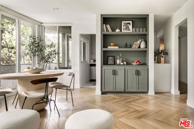 dining area featuring light parquet flooring and built in shelves