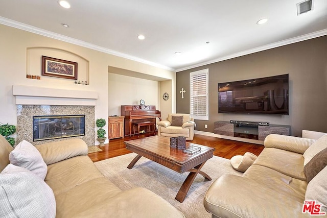 living room with crown molding and hardwood / wood-style flooring