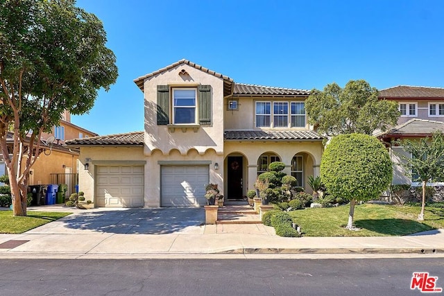 mediterranean / spanish-style house featuring a garage