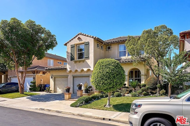 mediterranean / spanish-style house with a garage