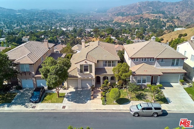 birds eye view of property featuring a mountain view