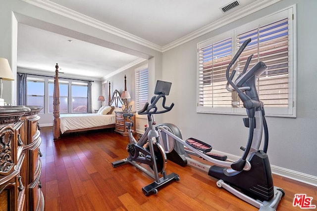 workout room with plenty of natural light, ornamental molding, and hardwood / wood-style floors