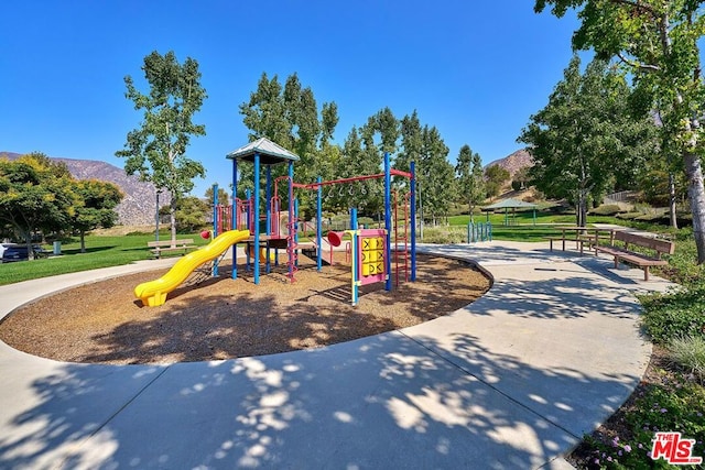 view of playground with a mountain view