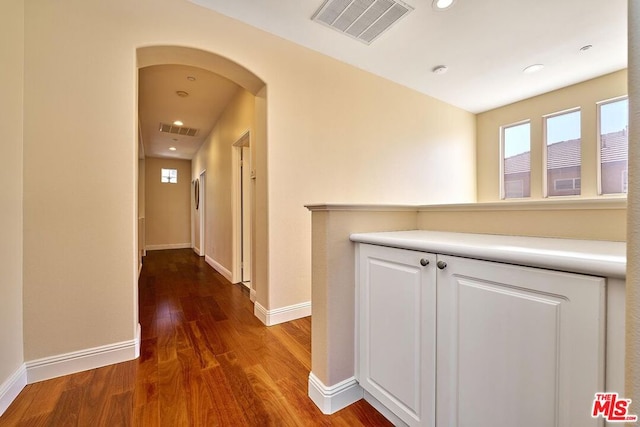 corridor featuring dark wood-type flooring