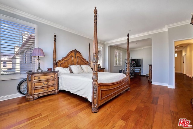 bedroom with crown molding and hardwood / wood-style flooring