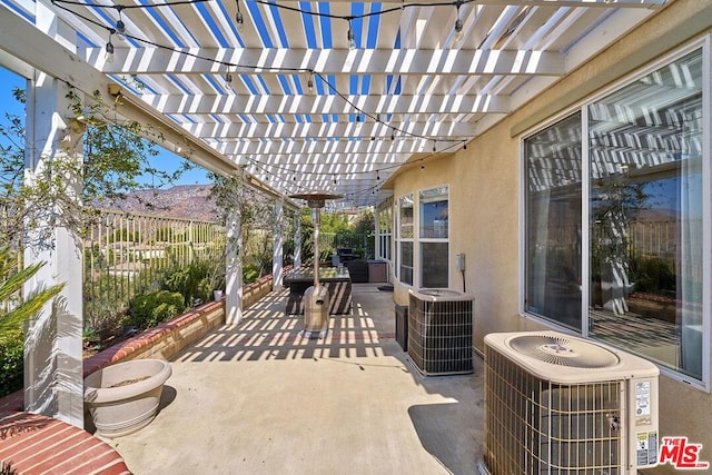 view of patio with central air condition unit and a pergola