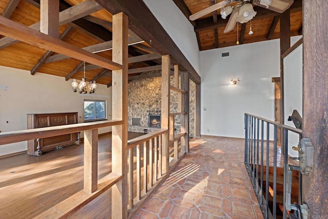 hall featuring a notable chandelier, wooden ceiling, high vaulted ceiling, and beamed ceiling