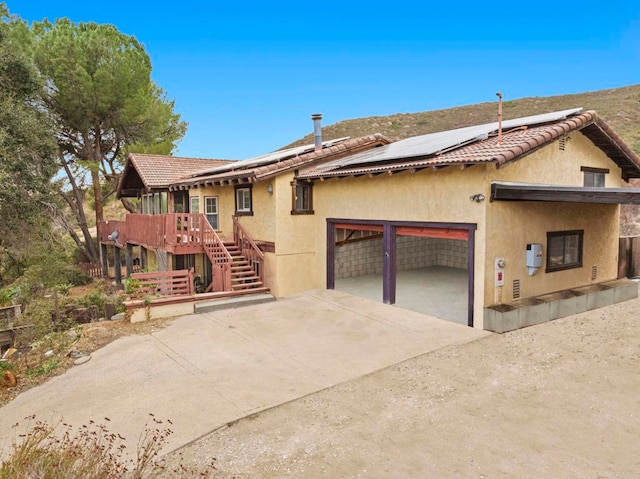 view of front of home with a garage and solar panels