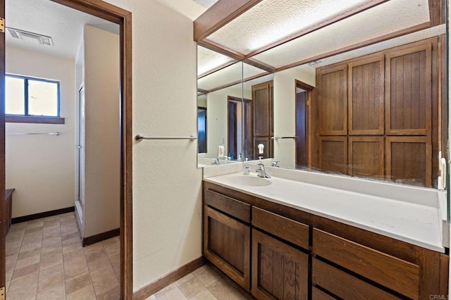 bathroom featuring walk in shower and vanity