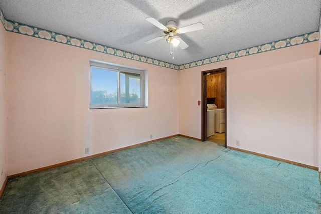 carpeted spare room featuring washer / dryer, a textured ceiling, and ceiling fan