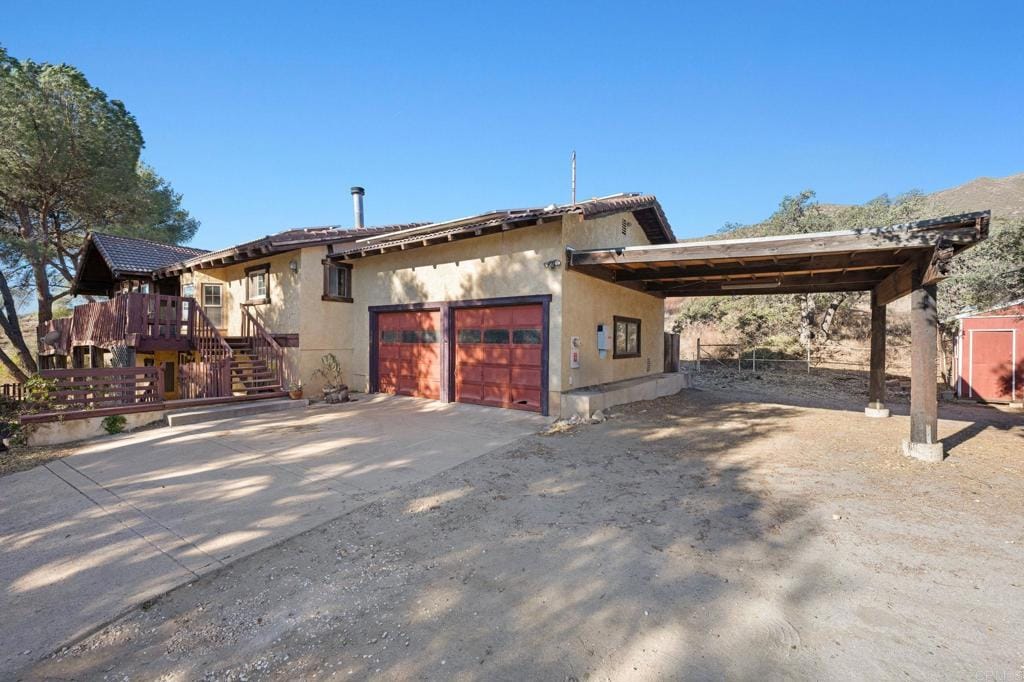 19781 Viejas Grade Rd, Alpine, CA 91901 - view of front facade featuring a garage and a carport