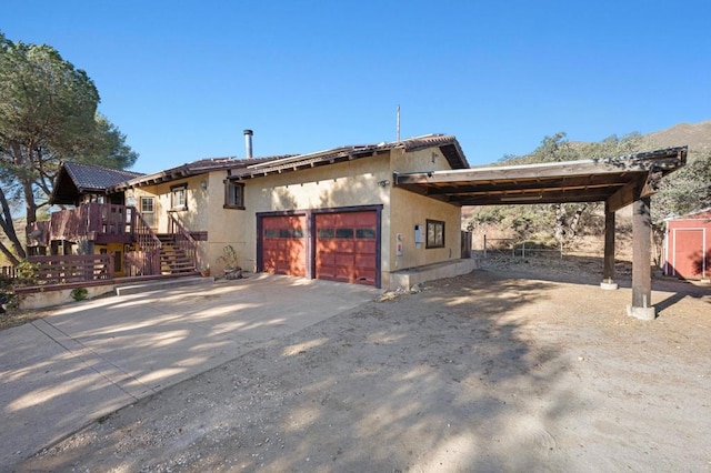 view of front facade featuring a garage and a carport