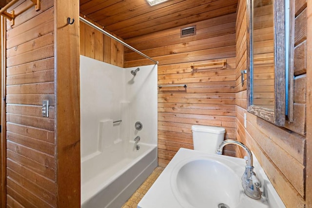 full bathroom featuring sink, wood ceiling, wood walls, and shower / bath combination