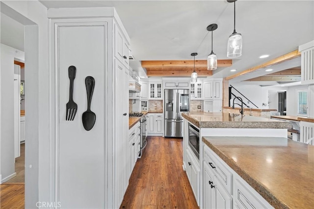 12475 Christmas Tree Rd, Ojai, CA 93023 - kitchen with tasteful backsplash, stainless steel appliances, dark wood-style floors, beam ceiling, and glass insert cabinets
