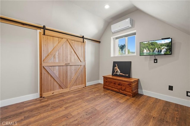 12475 Christmas Tree Rd, Ojai, CA 93023 - additional living space featuring hardwood / wood-style flooring, baseboards, a barn door, vaulted ceiling, and an AC wall unit