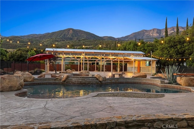 view of swimming pool with a mountain view