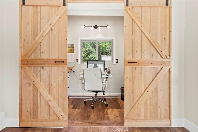 12475 Christmas Tree Rd, Ojai, CA 93023 - office space featuring baseboards, a barn door, and wood finished floors