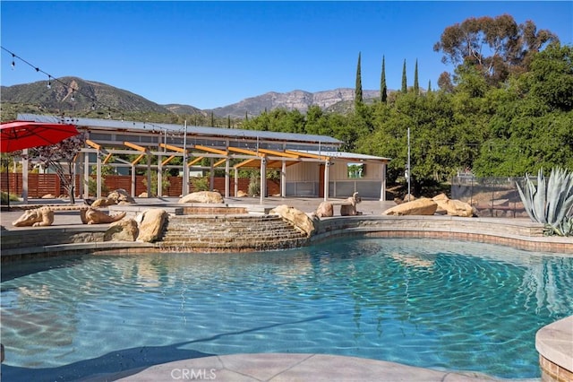 view of swimming pool with a mountain view